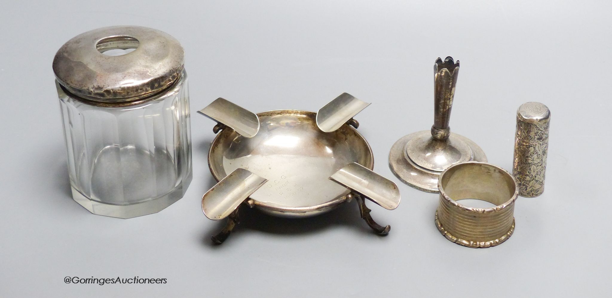 Small silver - a topped hair tidy, an ashtray, London 1900, 3.3oz., a napkin ring, a white metal scent bottle, 5.5cm, and a loaded posy holder, 7cm